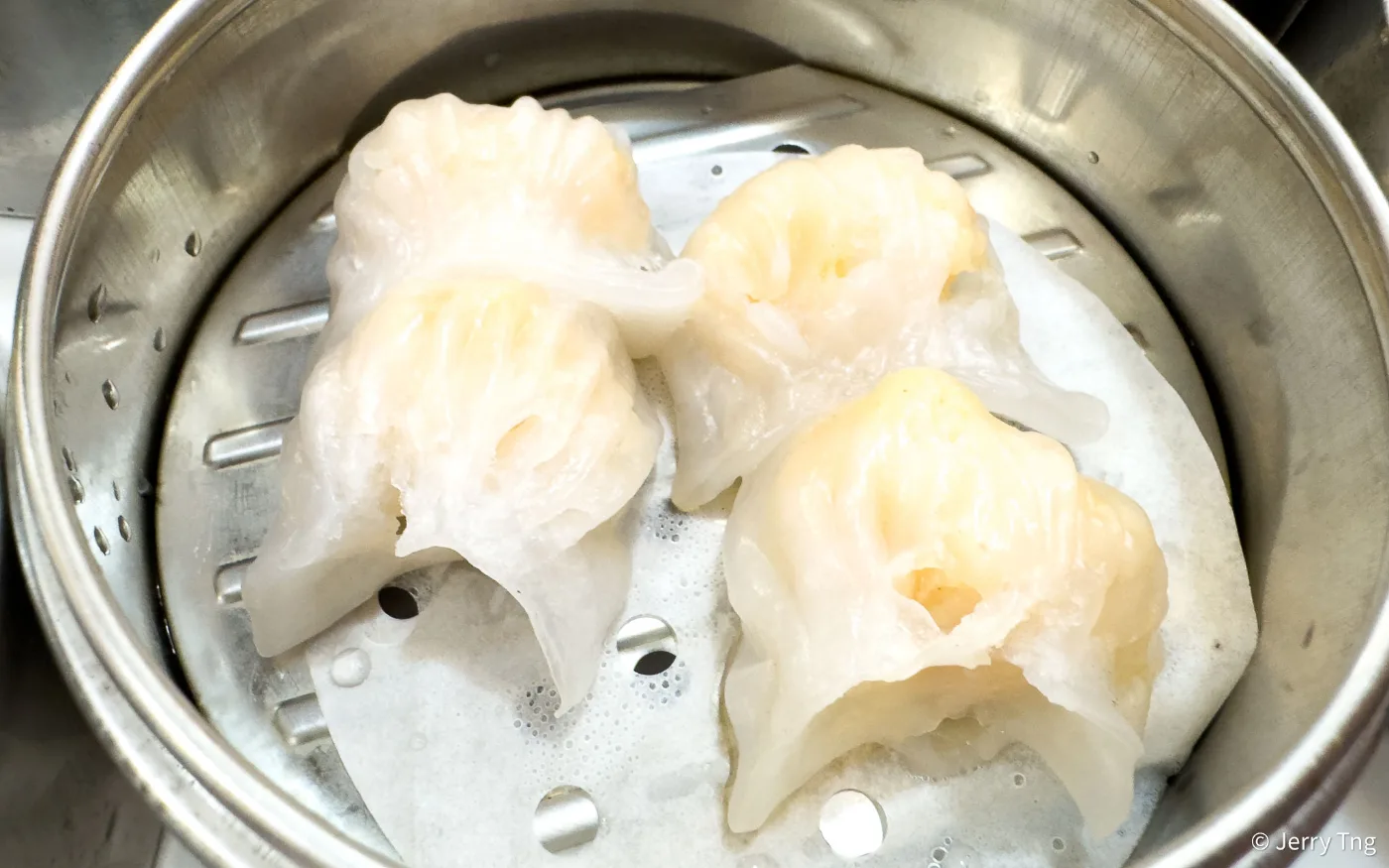 Four of 126 Dim Sum&rsquo;s har gow, translucent prawn dumplings, in a steel steamer