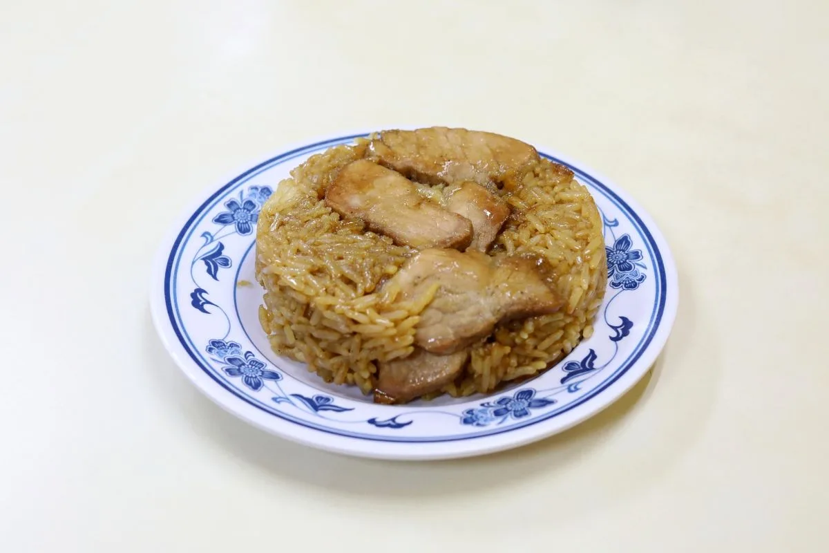 126 Dim Sum&rsquo;s lotus-leaf glutinous rice served unwrapped with soy chicken on a blue-patterned plate