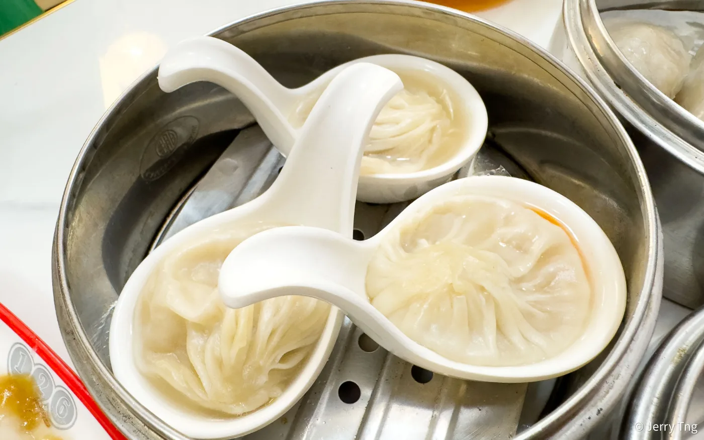 126 Dim Sum&rsquo;s xiao long bao, each soup dumpling served in its own white spoon